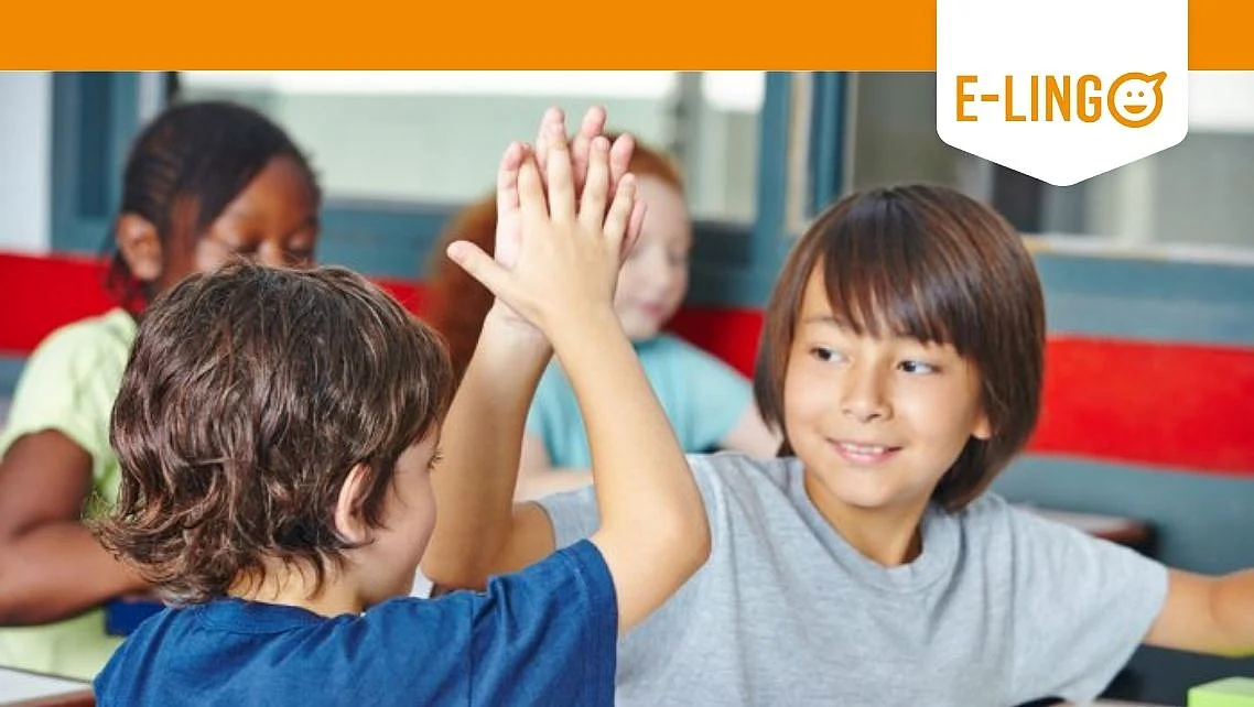 Two young boys high-five