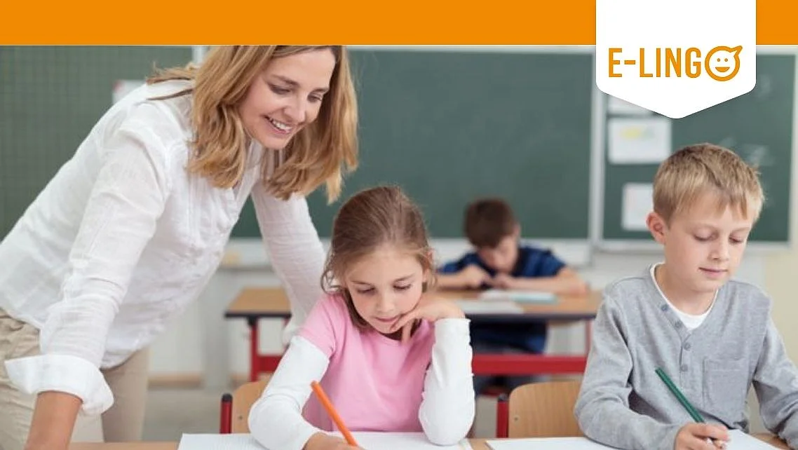 Smiling Teacher is looking at two students' work